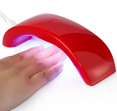 LED Nail Art Lamp curing gel polish with colorful LED lights, designed for professional and home use.